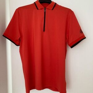 Bogner men's Cody functional short-sleeved polo in orange with black detailing a